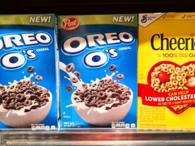 Cereal - Photograph of stacked cereal boxes featuring Oreo O’s and Cheerios, two popular breakfast cereals found in grocery stores. The image captures the colorful packaging and branding of these iconic products, often enjoyed with milk as part of a morning meal or snack. Perfect for illustrating breakfast culture, retail displays, and food marketing.