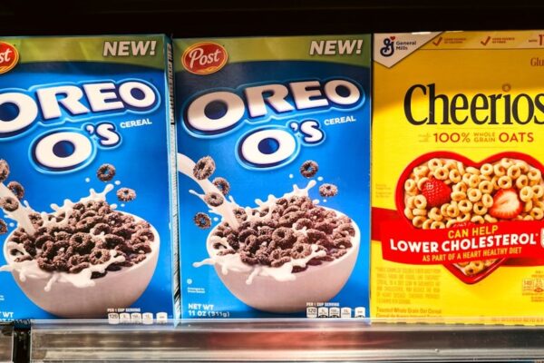 Cereal - Photograph of stacked cereal boxes featuring Oreo O’s and Cheerios, two popular breakfast cereals found in grocery stores. The image captures the colorful packaging and branding of these iconic products, often enjoyed with milk as part of a morning meal or snack. Perfect for illustrating breakfast culture, retail displays, and food marketing.